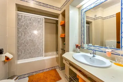 a bathroom with a sink and a mirror at Clementina Duplex apartment in Albufeira