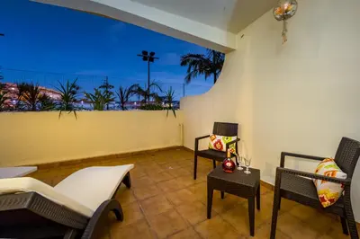 a room with chairs and a balcony with a view of the ocean at Clementina Duplex apartment in Albufeira