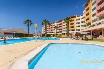 a swimming pool at a resort with a hotel at Clementina Duplex apartment in Albufeira