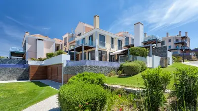a large house with a lawn in front of it at Emily in Vale do Lobo