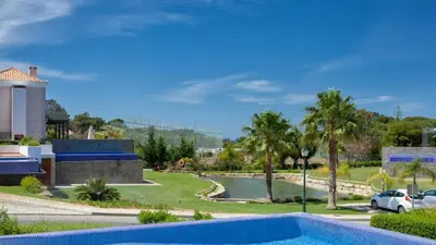 a villa with a swimming pool in a resort at Emily in Vale do Lobo
