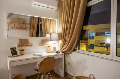 a home office with a desk and a window at Baixa de Faro Rooftop in Faro