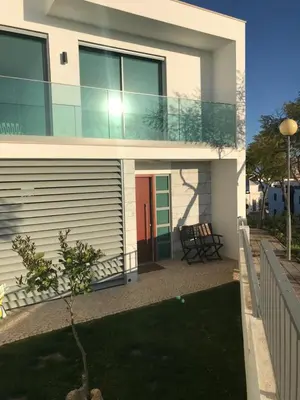 a house with a red door and a balcony at Vila Meluna in Albufeira