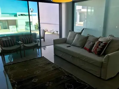a living room with a couch and a table at Vila Meluna in Albufeira
