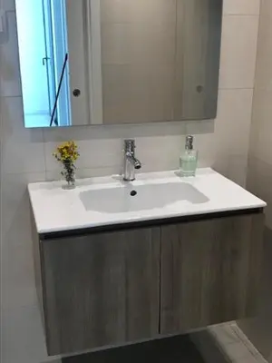a bathroom with a white sink and a mirror at Vila Meluna in Albufeira