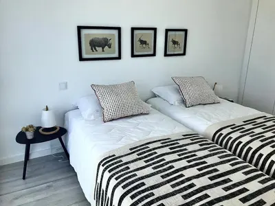 two beds sitting next to each other in a bedroom at Vila Meluna in Albufeira