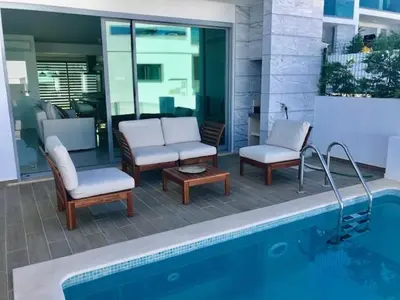 a swimming pool with two chairs at Vila Meluna in Albufeira