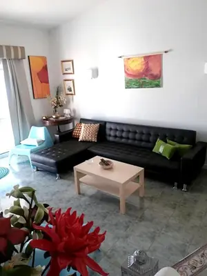 a living room with a black couch and a table at Luxurious villa in Albufeira with pool in Albufeira