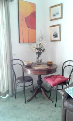 a dining room table with chairs and a vase with flowers at Luxurious villa in Albufeira with pool in Albufeira