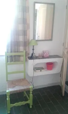 a bathroom with a sink and a chair and a mirror at Luxurious villa in Albufeira with pool in Albufeira