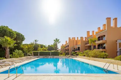 a swimming pool in front of a building at AL - Apartamentos Vila Sol F5 Bloco 3 in Quarteira