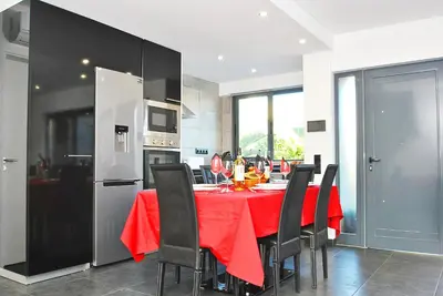 a kitchen with a table with a red table cloth at Villa Waikiki by Algarve Vacation in Albufeira