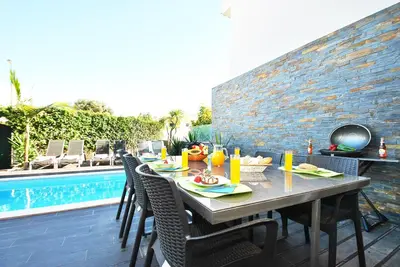 a table with food on it next to a pool at Villa Waikiki by Algarve Vacation in Albufeira