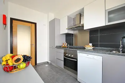 a kitchen with a bowl of fruit on a counter at Apartment Caracas 1 by Algarve Vacation in Albufeira
