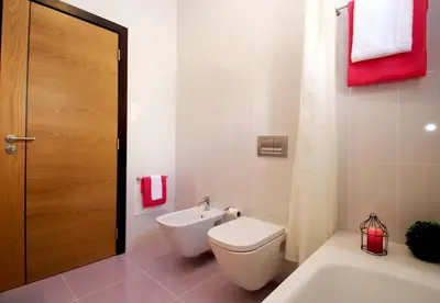 a bathroom with a toilet and a tub and a sink at Apartment Caracas 1 by Algarve Vacation in Albufeira