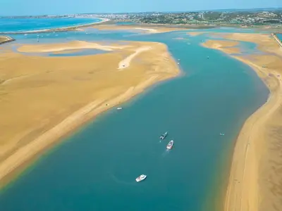 two boats in the water on the beach at Apartment Caracas 1 by Algarve Vacation in Albufeira