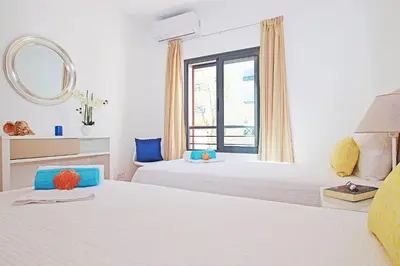 a bedroom with two beds and a window at Apartment Caracas 2 by Algarve Vacation in Albufeira