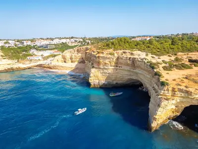 an aerial view of boats in the water next to a large cliff at Apartment Caracas 2 by Algarve Vacation in Albufeira