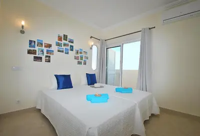a bedroom with a bed with blue trays on it at Villa Moorea by Algarve Vacation in Guia