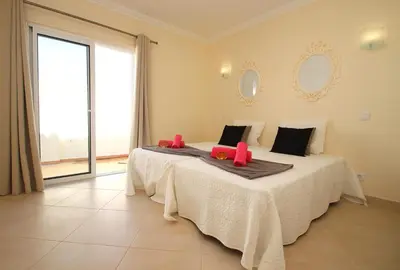 a bedroom with a bed with red pillows on it at Villa Moorea by Algarve Vacation in Guia