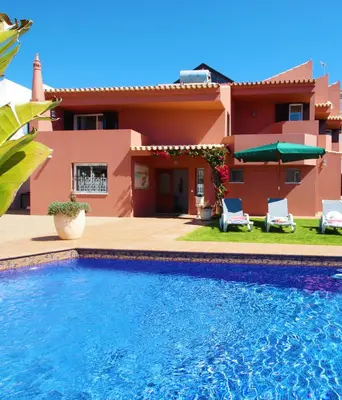 a house with a swimming pool in front of a house at Villa Saint Martin by Algarve Vacation in Albufeira
