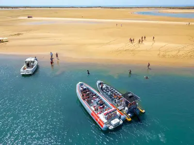 two boats in the water next to a beach at Apartment Mykonos by Algarve Vacation in Albufeira