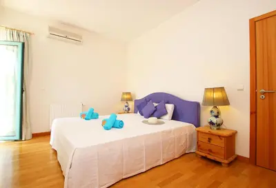 a bedroom with a bed with blue pillows on it at Apartment Mykonos by Algarve Vacation in Albufeira