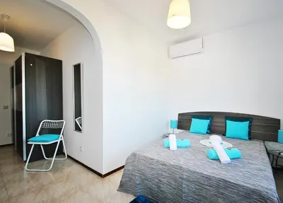 a bedroom with a large bed with blue pillows at Villa Zanzibar by Algarve Vacation in Olhos de Água