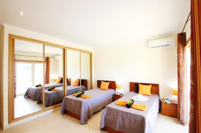 a bedroom with two beds and a large mirror at Villa Pauline by Algarve Vacation in Albufeira