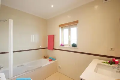 a white bathroom with a tub and a sink at Villa Pauline by Algarve Vacation in Albufeira
