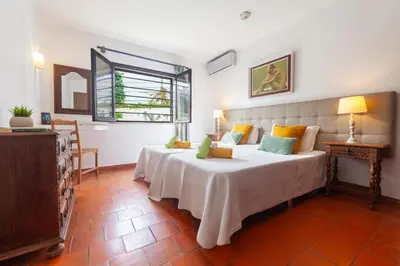 a bedroom with a large white bed and a window at Villa Kailua by Algarve Vacation in Albufeira
