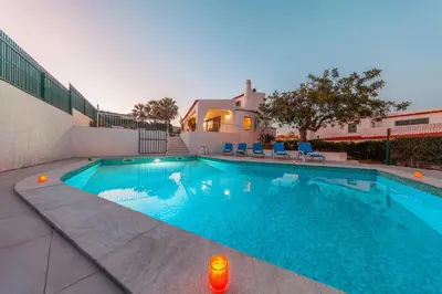 a swimming pool in front of a house at Villa Kailua by Algarve Vacation in Albufeira