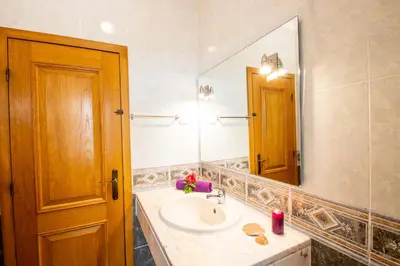 a bathroom with a sink and a large mirror at Villa Boracay by Algarve Vacation in Albufeira