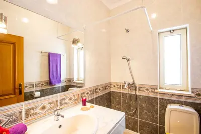 a bathroom with a sink and a toilet and a mirror at Villa Boracay by Algarve Vacation in Albufeira