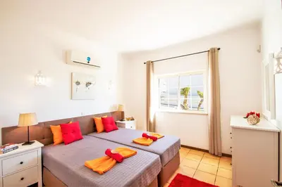 a bedroom with two beds and a window at Villa Boracay by Algarve Vacation in Albufeira