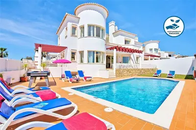 a villa with a swimming pool and a house at Villa Melanésia by Algarve Vacation in Guia