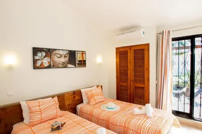 a living room with two beds and a balcony at Villa Krabi by Algarve Vacation in Albufeira