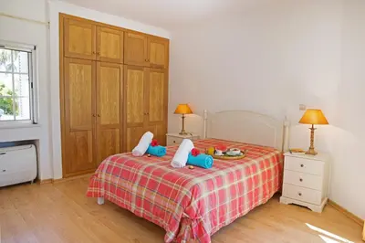 a bedroom with a bed with two pillows on it at Villa Tulum by Algarve Vacation in Almancil