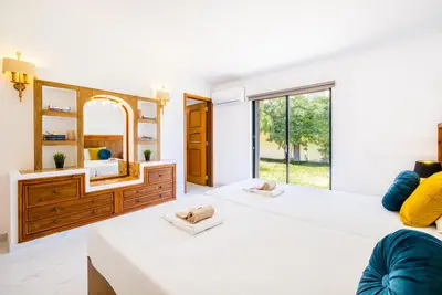 a bedroom with two beds and a mirror at Villa Crisandra by Algarve Vacation in Albufeira