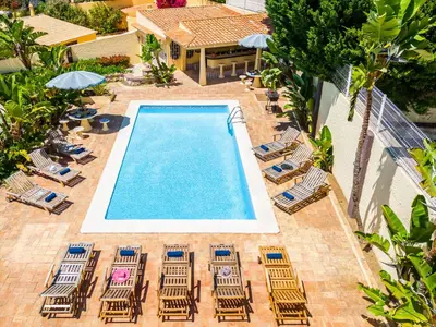 an overhead view of a swimming pool with chairs and umbrellas at Villa Crisandra by Algarve Vacation in Albufeira