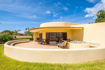a house with a circular patio in the yard at Villa Crisandra by Algarve Vacation in Albufeira