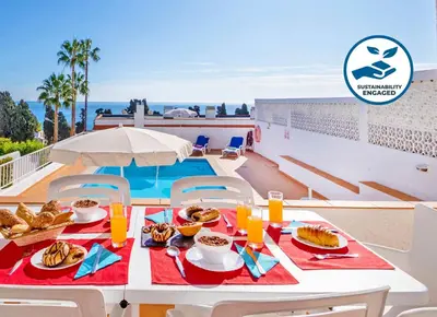 a table with food on it next to a pool at Villa Turtle Beach by Algarve Vacation in Albufeira