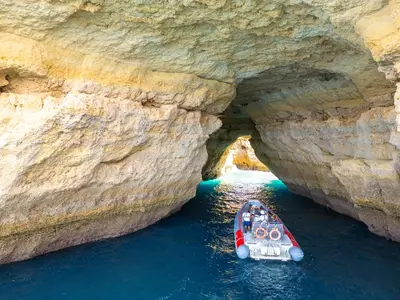 a boat in a cave in the water at Villa Turtle Beach by Algarve Vacation in Albufeira