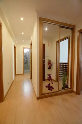 an empty hallway with a room with a glass door at Eugenia's House in Faro