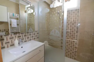 a bathroom with a sink and a shower at Eugenia's House in Faro
