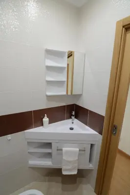 a bathroom with a white sink and a mirror at Eugenia's House in Faro