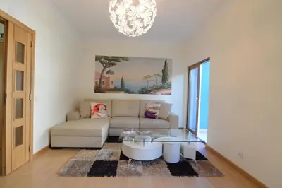 a living room with a couch and a glass table at Eugenia's House in Faro