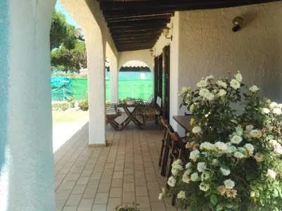 a porch with a view of the ocean and flowers at Alsouk in Vilamoura
