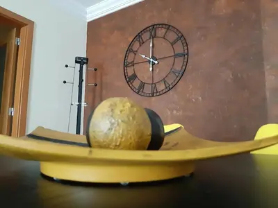 a clock and a melon on a table next to a banana at Apartamento Alfarrobeira Mar in Quarteira