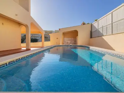 a swimming pool in front of a house at Villa Flor de Maio by Interhome in Patroves